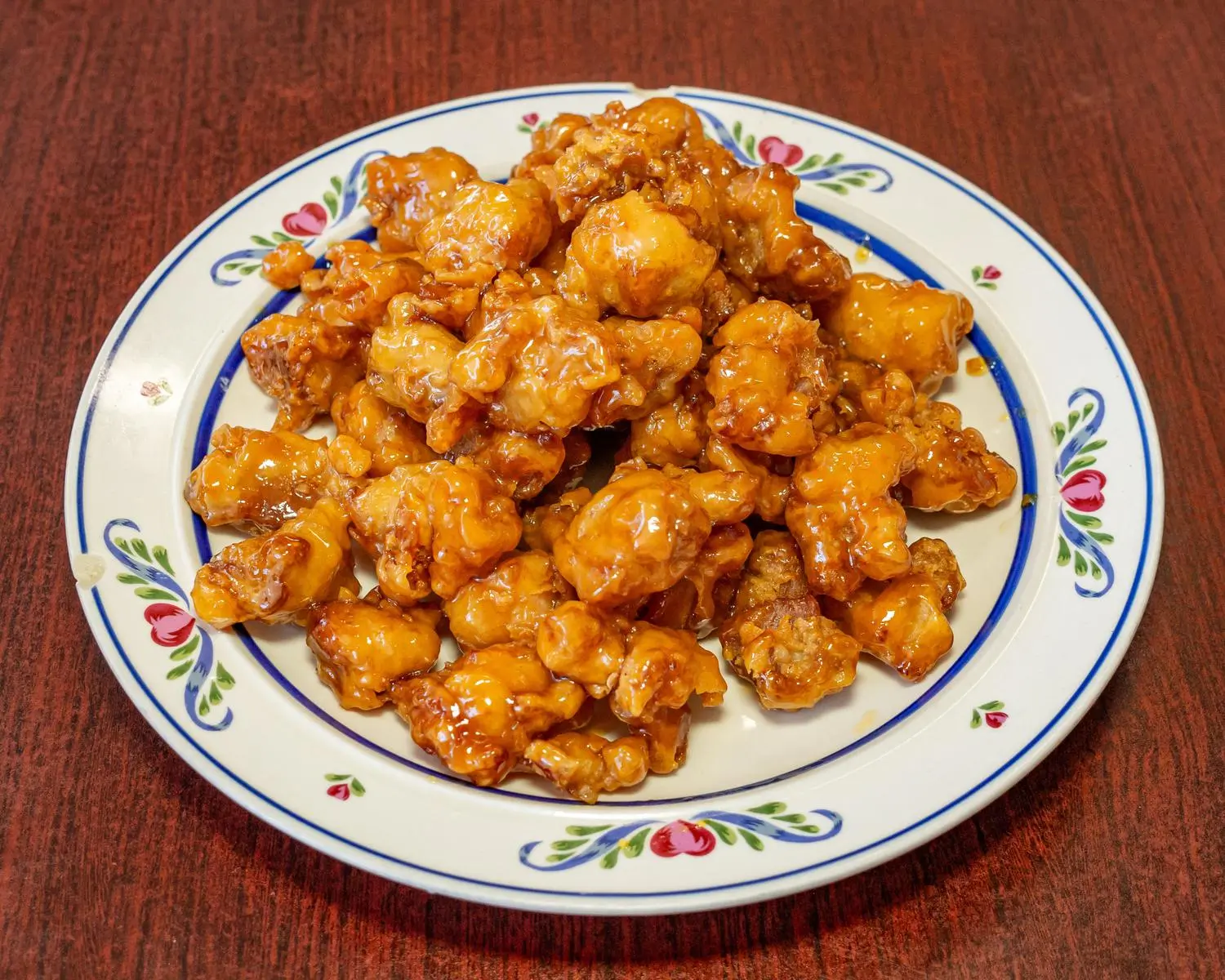 A plate of orange chicken rice, featuring crispy chicken pieces in an orange - flavored sauce at Uncle Yu Restaurant，a Chinese Restaurant in Union City