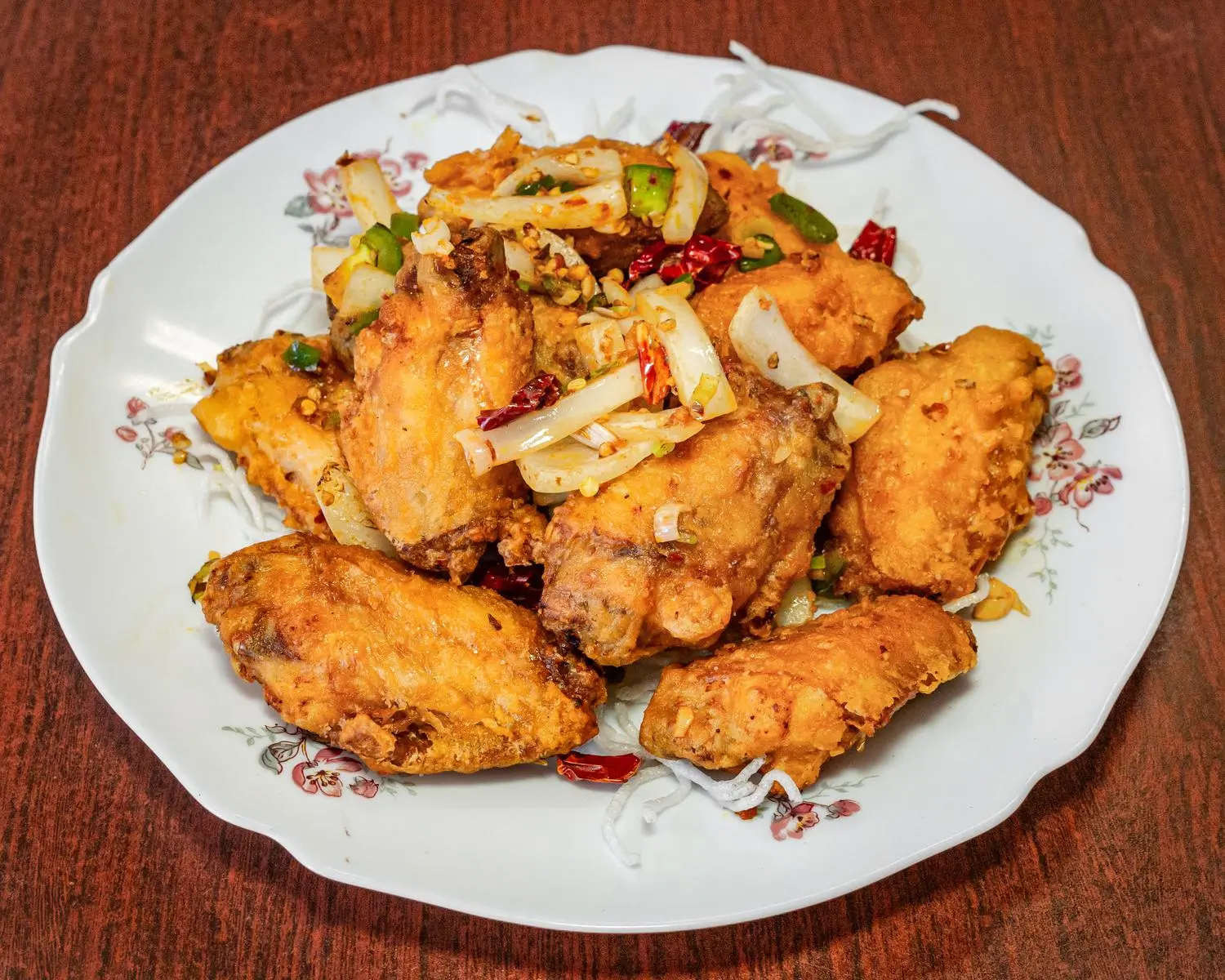 A plate of fried chicken wings, showing golden - brown, crispy - skinned chicken wings at Uncle Yu Restaurant，a Chinese Restaurant in Union City